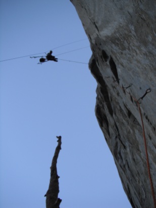 Erik cleaning one of the overhanging bolt Ladders at the start of The West face of Leaning Tower on rappel